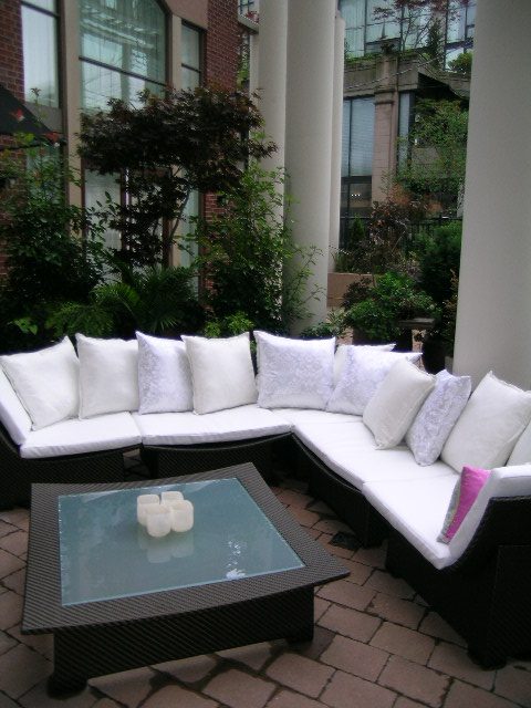 Outdoor patio with white cushioned seating and a glass coffee table. - 202 -1280 Richards Street, Vancouver Downtown