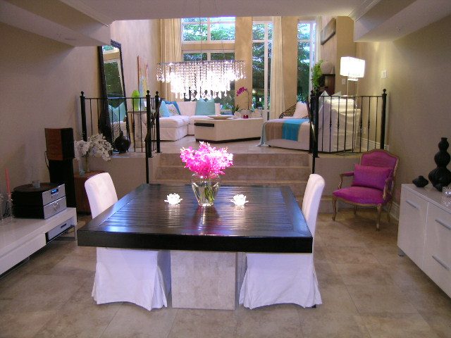 Spacious open-concept living and dining area with modern decor, large windows, and a chandelier. - 202 -1280 Richards Street, Vancouver Downtown