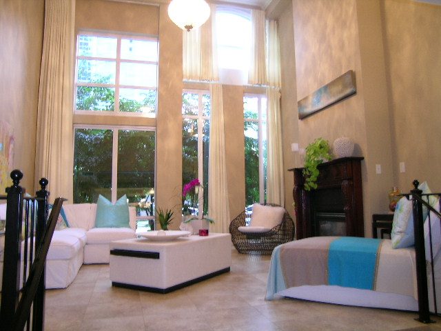 Bright living room with large windows, modern furniture, and a city view. - 202 -1280 Richards Street, Vancouver Downtown
