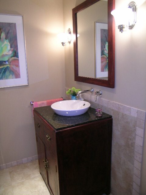 Bright bathroom with dark wood vanity, granite countertop, and wall-mounted sconces. - 202 -1280 Richards Street, Vancouver Downtown
