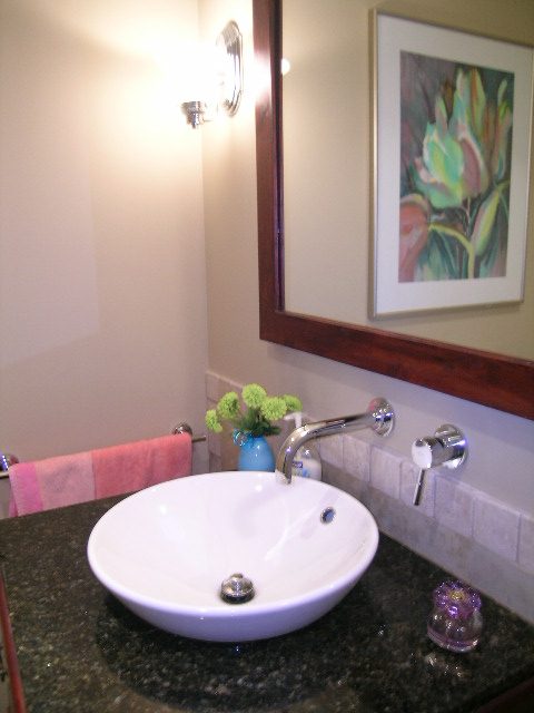 Bathroom with granite countertop and modern sink, framed floral art on wall. - 202 -1280 Richards Street, Vancouver Downtown