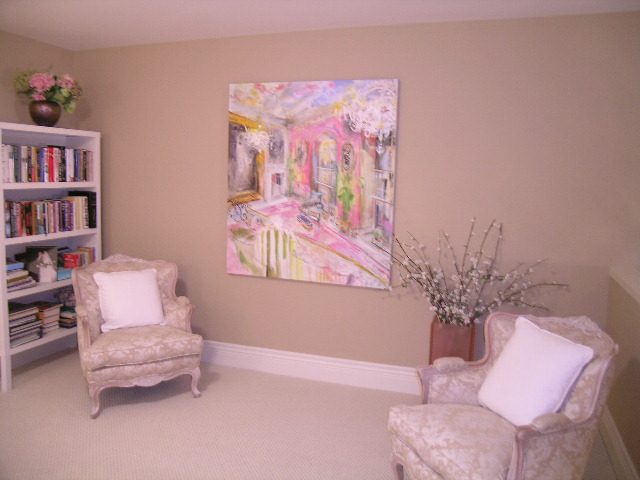 Living room with pastel artwork, floral decor, and cozy armchairs. - 202 -1280 Richards Street, Vancouver Downtown