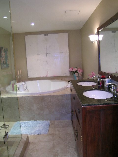 Spacious bathroom with marble countertops, wooden cabinets, and a large mirror. - 202 -1280 Richards Street, Vancouver Downtown