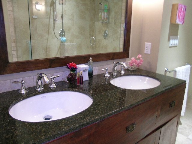 Bathroom with dual sinks, dark granite countertop, and wooden vanity. - 202 -1280 Richards Street, Vancouver Downtown