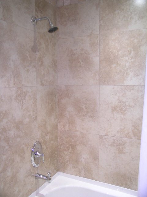Bathroom with beige tile walls and a shower head. - 202 -1280 Richards Street, Vancouver Downtown