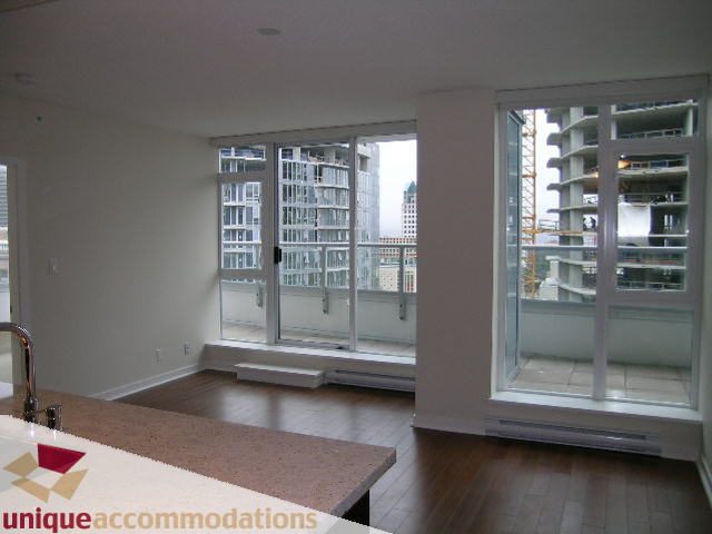 Bright kitchen with granite countertops and hardwood floors, showcasing a city view. - 1802 - 821 Cambie Street, Vancouver Downtown