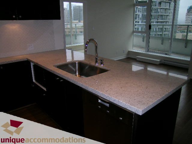 Bright kitchen with granite countertops, stainless steel sink, and city view. - 1802 - 821 Cambie Street, Vancouver Downtown