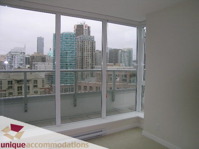 Bright living room with large windows offering a stunning city view. - 1802 - 821 Cambie Street, Vancouver Downtown