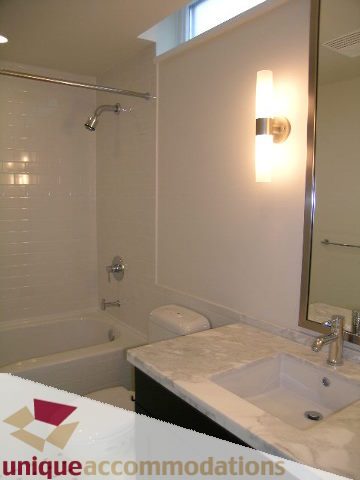 Furnished bathroom with marble countertops and modern lighting. - 1802 - 821 Cambie Street, Vancouver Downtown
