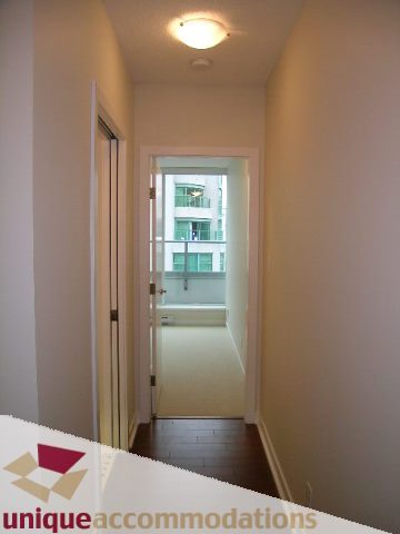 Furnished hallway leading to a bright room with a city view. - 1802 - 821 Cambie Street, Vancouver Downtown
