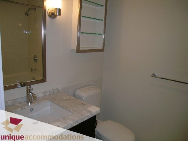Furnished bathroom with marble countertops and a modern sink setup. - 1802 - 821 Cambie Street, Vancouver Downtown
