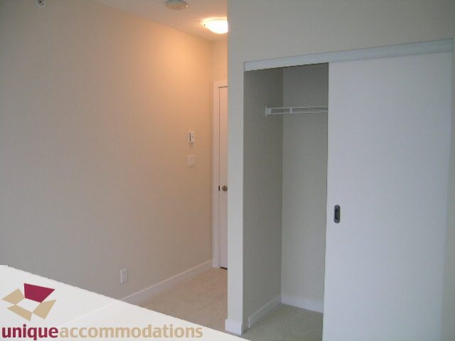 Bright hallway with sliding closet doors and carpeted floors. - 1802 - 821 Cambie Street, Vancouver Downtown