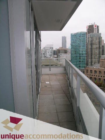Furnished balcony with city view and modern architecture. - 1802 - 821 Cambie Street, Vancouver Downtown