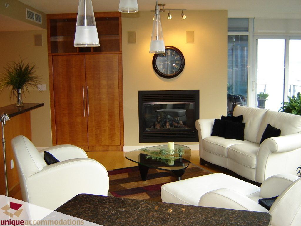 Spacious living room with modern furniture, wood accents, and a cozy fireplace. - 1803 - 1233  W Cordova Street, Vancouver Downtown