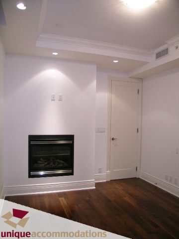Furnished living room with hardwood floors and built-in fireplace. - 1501 - 1280 Richards Street, Vancouver Downtown