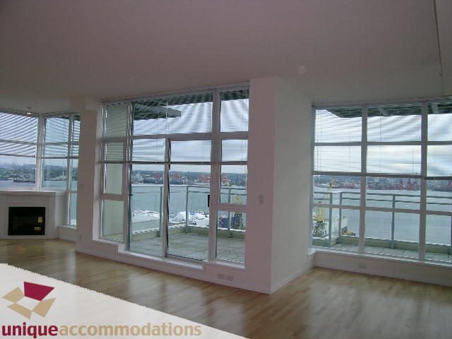 Spacious penthouse living room with hardwood floors and city view. - 2301 - 188 E Esplanade, North Vancouver