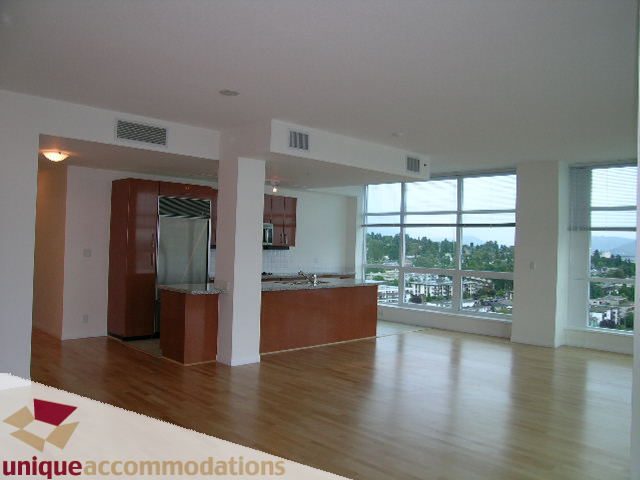 Spacious open-concept penthouse with hardwood floors, kitchen counter, and city view. - 2301 - 188 E Esplanade, North Vancouver
