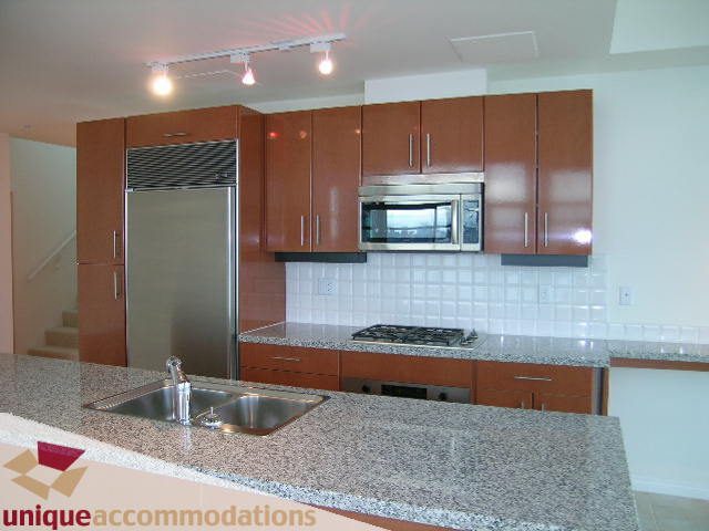 Bright kitchen with granite countertops and stainless steel appliances. - 2301 - 188 E Esplanade, North Vancouver