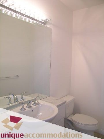 Bathroom with white sink, countertop, and toilet. - 2301 - 188 E Esplanade, North Vancouver