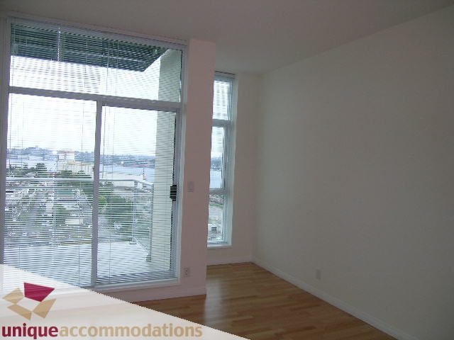 Bright living room with hardwood floors and city view. - 2301 - 188 E Esplanade, North Vancouver