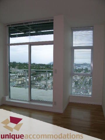 Bright living room with hardwood floors and a city view. - 2301 - 188 E Esplanade, North Vancouver