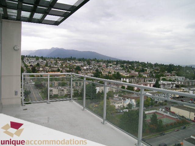 Furnished penthouse with panoramic city view and modern balcony railings. - 2301 - 188 E Esplanade, North Vancouver