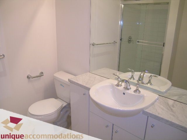 Bright bathroom with white fixtures and marble countertop. - 2301 - 188 E Esplanade, North Vancouver