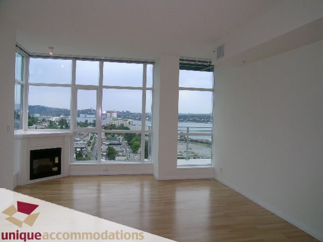 Spacious penthouse living room with hardwood floors and city view. - 2301 - 188 E Esplanade, North Vancouver