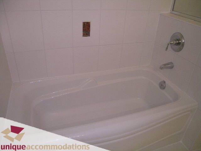 Bathroom with white tile walls and modern fixtures. - 2301 - 188 E Esplanade, North Vancouver