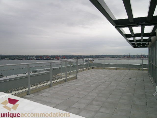 Penthouse balcony with city view and modern railings. - 2301 - 188 E Esplanade, North Vancouver