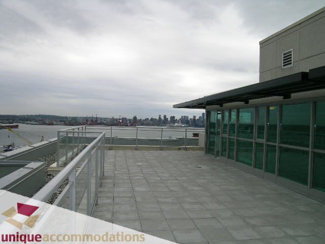Furnished penthouse with expansive city view and modern balcony. - 2301 - 188 E Esplanade, North Vancouver