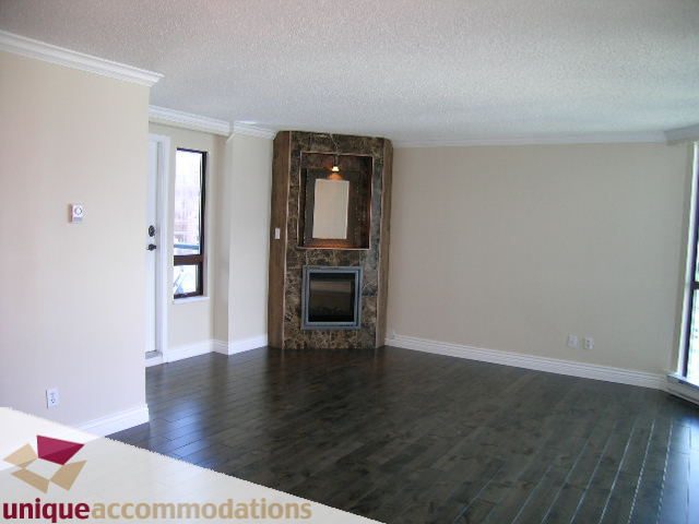 Bright living room with hardwood floors and a marble fireplace. - 2201 - 1415 West Georgia, Vancouver Downtown