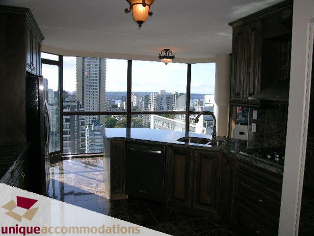Bright kitchen with dark countertops and city view, modern design. - 2201 - 1415 West Georgia, Vancouver Downtown