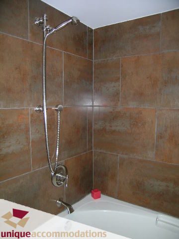 Bathroom with modern shower setup and tiled walls. - 2201 - 1415 West Georgia, Vancouver Downtown