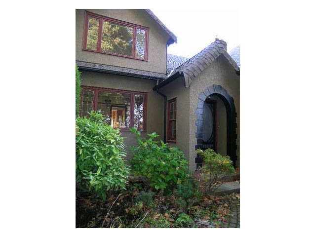 Spacious 4-bedroom + den house with a charming arched entryway and lush greenery surrounding the property. - 3828 West 8th Ave, Vancouver West Side