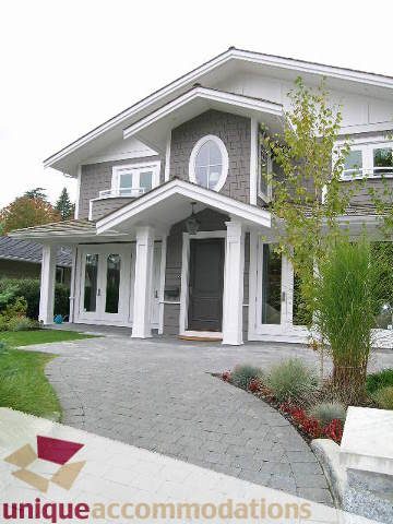Furnished 4-bedroom house with a welcoming front porch and a paved driveway. - 1365 Kings Ave, West Vancouver