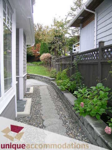 Furnished patio with stone path and garden plants. - 1365 Kings Ave, West Vancouver