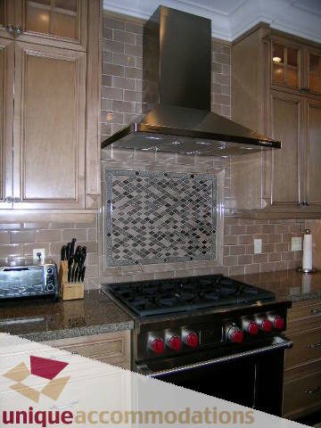 Bright kitchen with granite countertops and stainless steel appliances, showcasing a modern design. - 1365 Kings Ave, West Vancouver