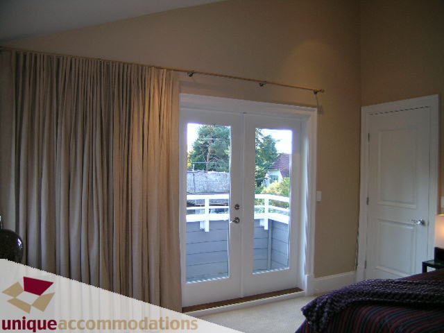 Spacious bedroom with large windows and a view of the trees. - 1365 Kings Ave, West Vancouver