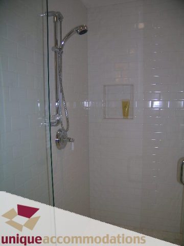 Shower with glass door, modern fixtures, white tiles. - 1365 Kings Ave, West Vancouver