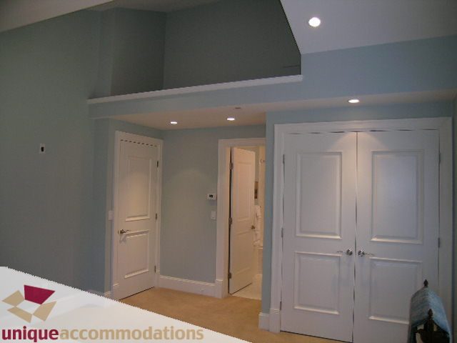 Furnished entryway with white doors and light blue walls. - 1365 Kings Ave, West Vancouver