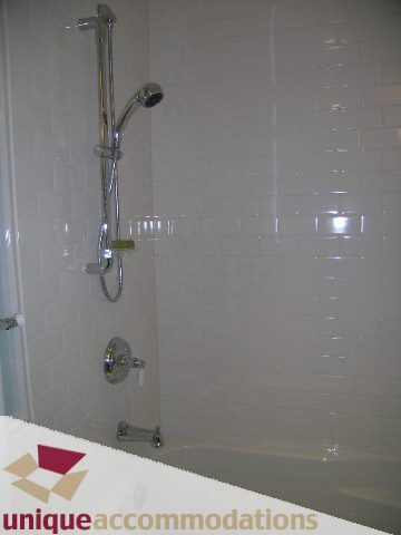 Bathroom with modern shower and bathtub setup. - 1365 Kings Ave, West Vancouver