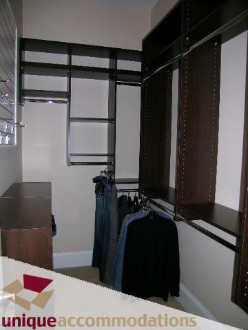 Spacious walk-in closet with built-in shelves and hanging space. - 1365 Kings Ave, West Vancouver