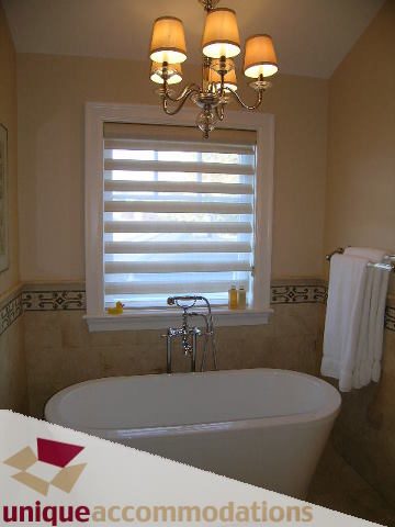 Spacious bathroom with freestanding tub and chandelier. - 1365 Kings Ave, West Vancouver