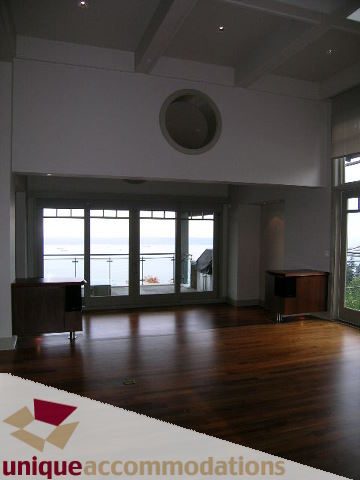 Open-concept living area with hardwood floors and a city view. - 2436 Hudson Court, West Vancouver
