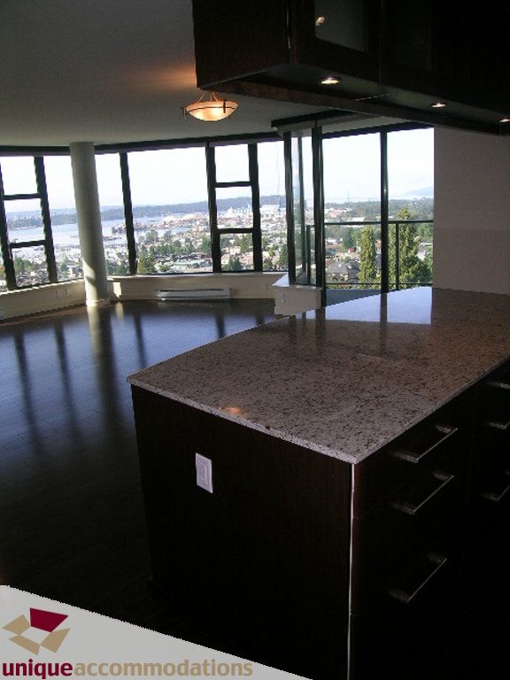 Bright kitchen with granite countertops, hardwood floors, and a stunning city view. - 905 - 683 Victoria Park West, North Vancouver