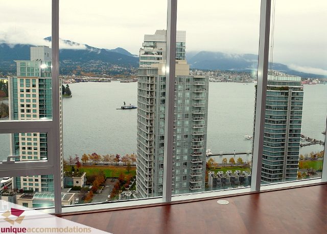Furnished living room with hardwood floors and stunning city view. - 2802 - 1277 Melville Street, Vancouver Downtown