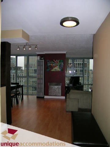 Bright living room with hardwood floors, city view, and modern furnishings. - 2803 - 930 Cambie Street, Vancouver Downtown