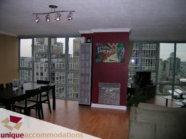 Furnished living room with hardwood floors, city view, and modern decor. - 2803 - 930 Cambie Street, Vancouver Downtown