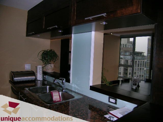 Bright kitchen with granite countertops, city view, and modern cabinetry. - 2803 - 930 Cambie Street, Vancouver Downtown